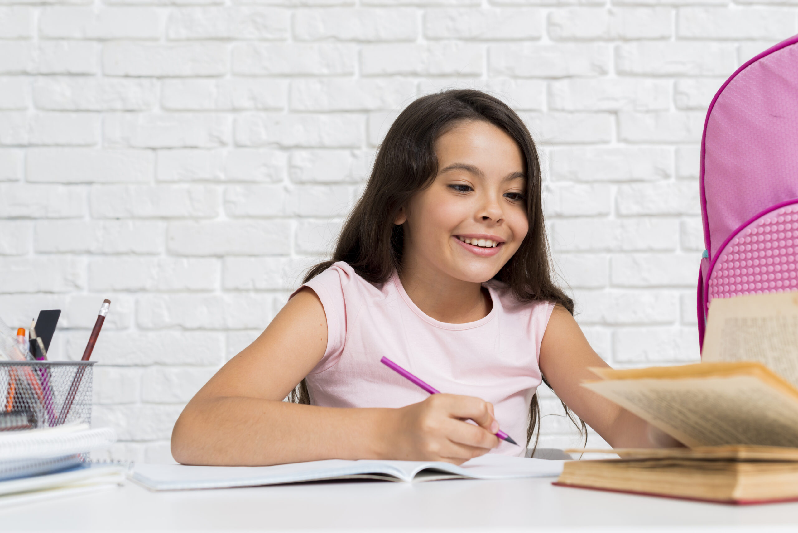 smiling-hispanic-girl-doing-home-assignment